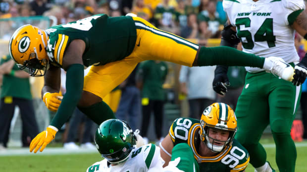 Green Bay Packers linebacker Chauncey Rivers (47) leaps over New York Jets quarterback Mike White (5) after White was tackled by Green Bay Packers' Jack Heflin (90) in the second half during their preseason football game on Saturday, August 21, 2021, at Lambeau Field in Green Bay, Wis. Mjs Gpg Heflin 08212021 0020